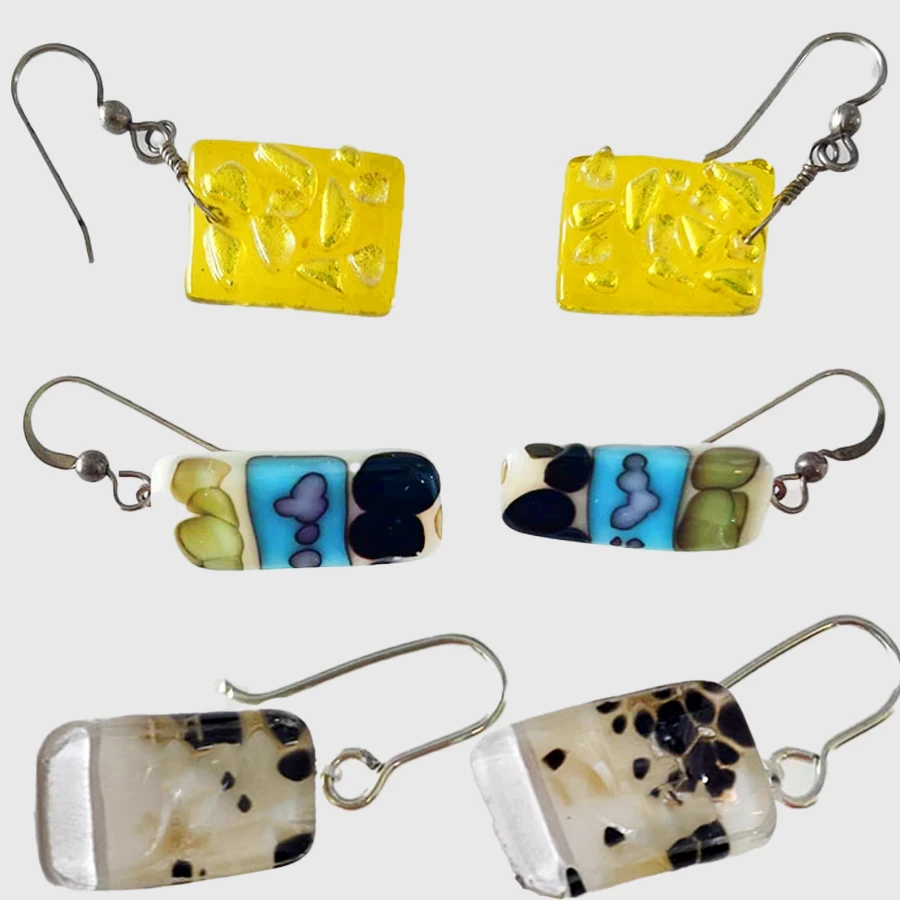 A collection of three unique rectangular glass earrings with various patterns and colors, each pair made at the Glass Duchess Studio in Port Charlotte, FL