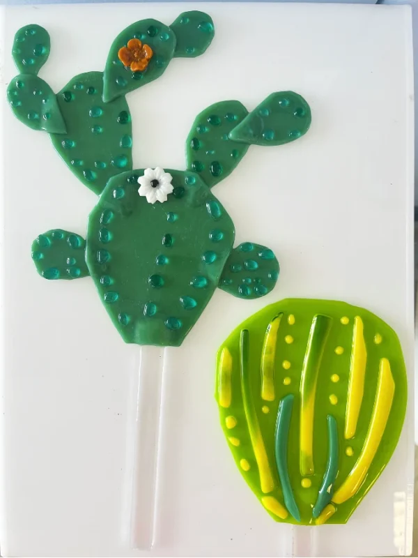 Two decorative plant stakes in the shape of various cactus plants made at Glass Duchess Studio, Port Charlotte FL