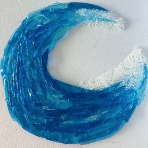 Decorative blue glass in the shape of an ocean wave curling over, made at Glass Duchess Studio in Port Charlotte FL