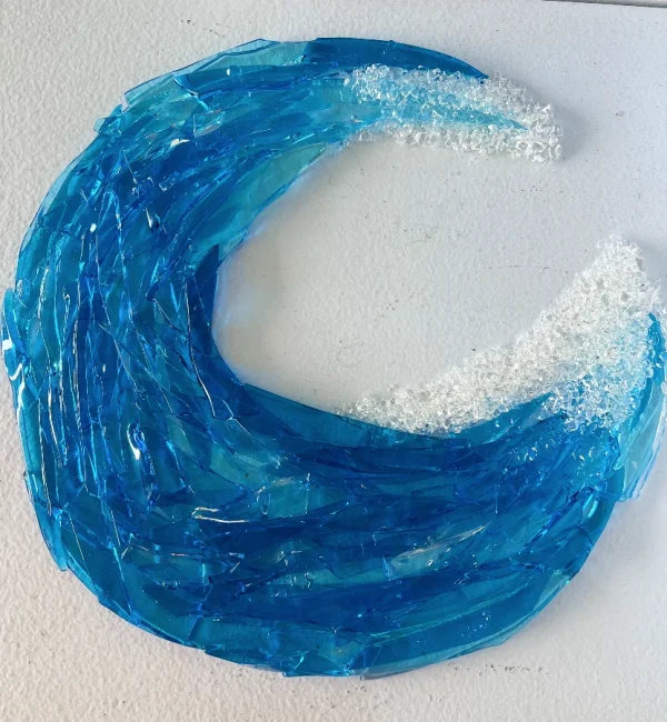 Decorative blue glass in the shape of an ocean wave curling over, made at Glass Duchess Studio in Port Charlotte FL